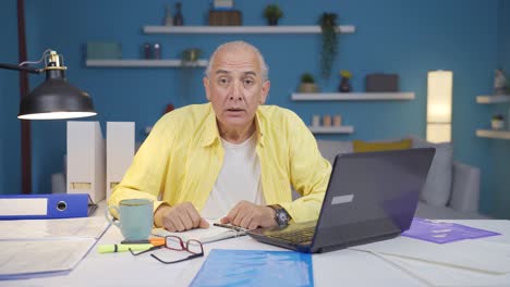 Home-office-worker-old-man-says-wow-to-camera.